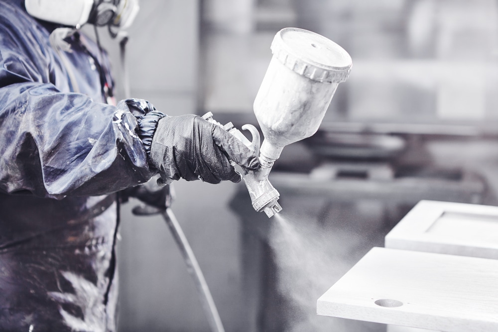 Close,Up,Image,Of,Carpenter,Painting,With,A,Paint,Spray